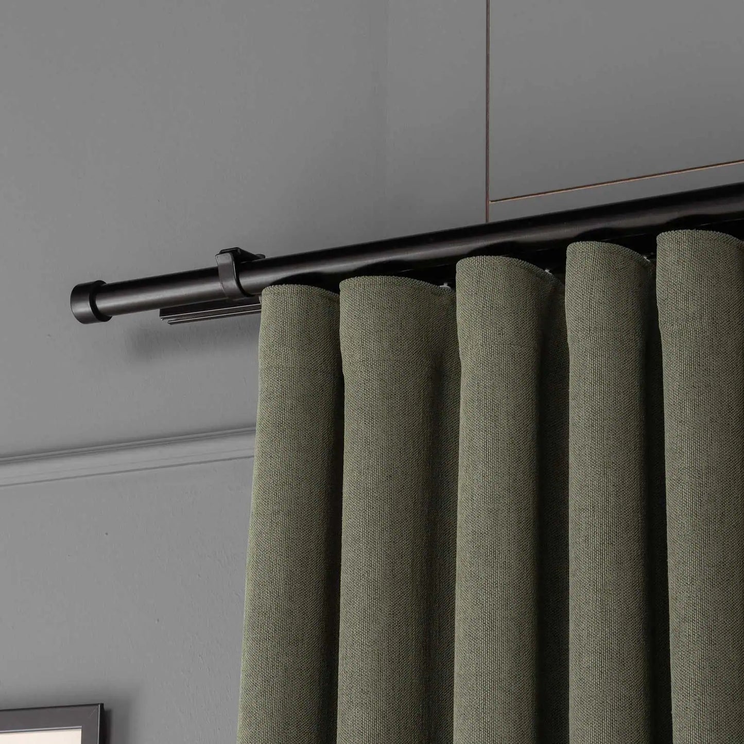 Top view showing the pleated header and curtain rod of 100% Blackout Pleated Linen Curtain Panels in Olive Green.