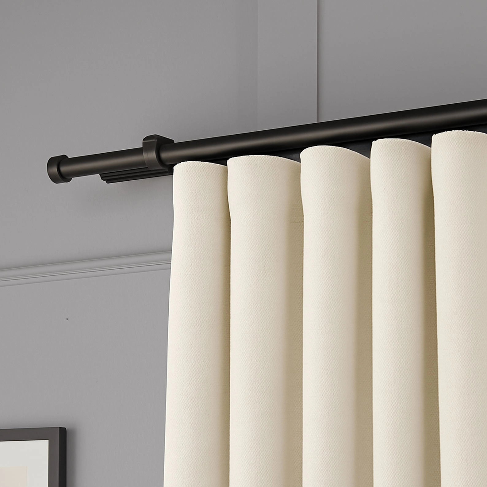 Side angle showing the fabric drape and thickness of 100% Blackout Pleated Linen Curtain Panels in Cream White.