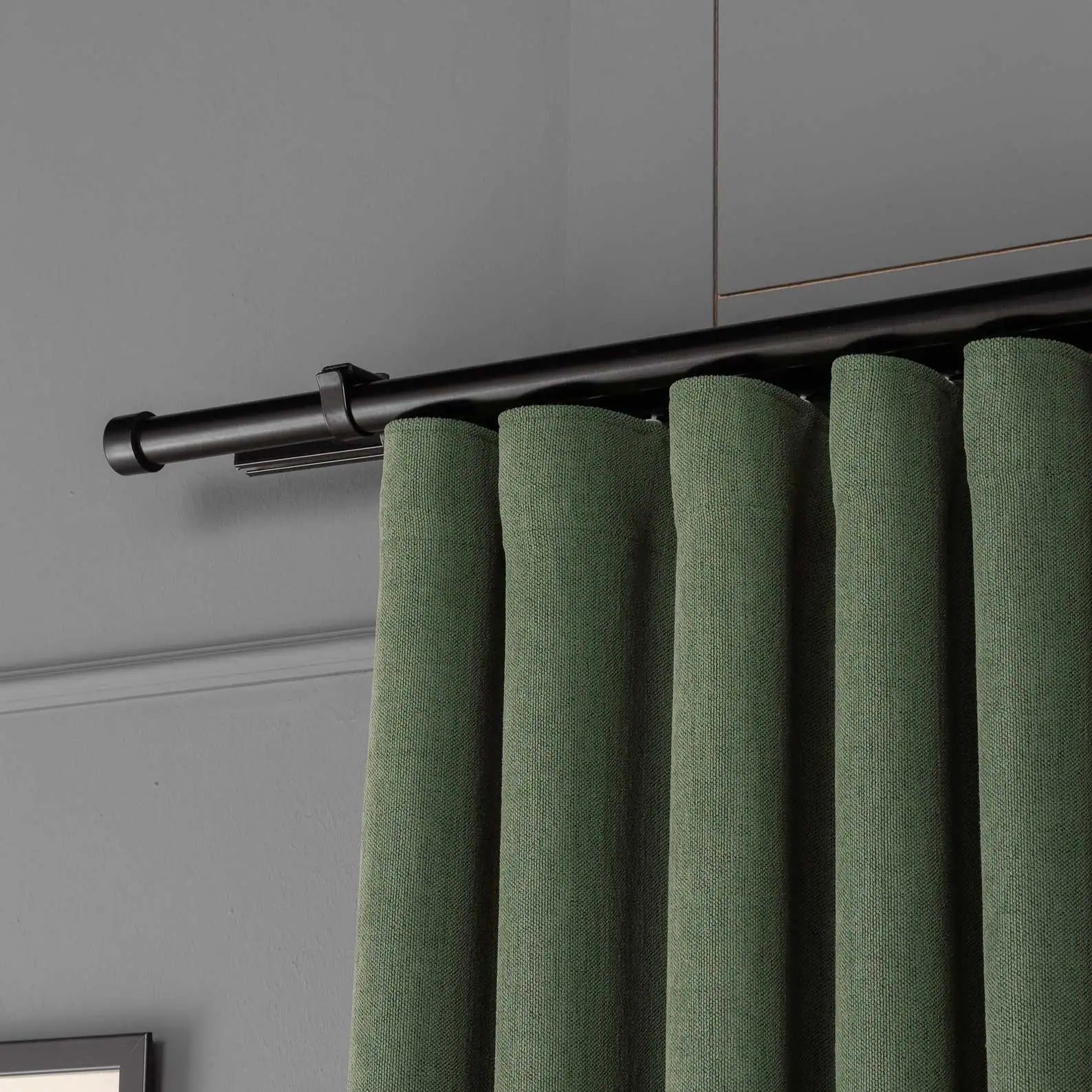 Top view showing the pleated header and curtain rod of 100% Blackout Pleated Linen Curtain Panels in Matcha Green.