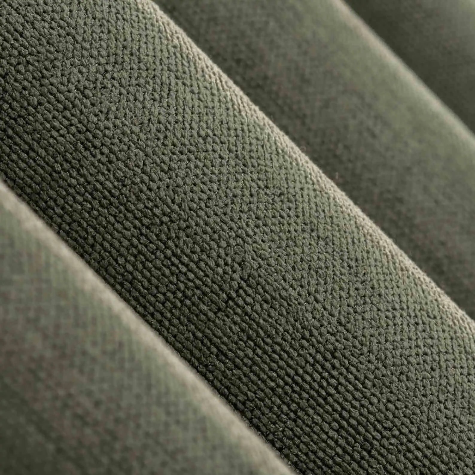 Close-up view of the linen texture and pleats of 100% Blackout Pleated Linen Curtain Panels in Olive Green.